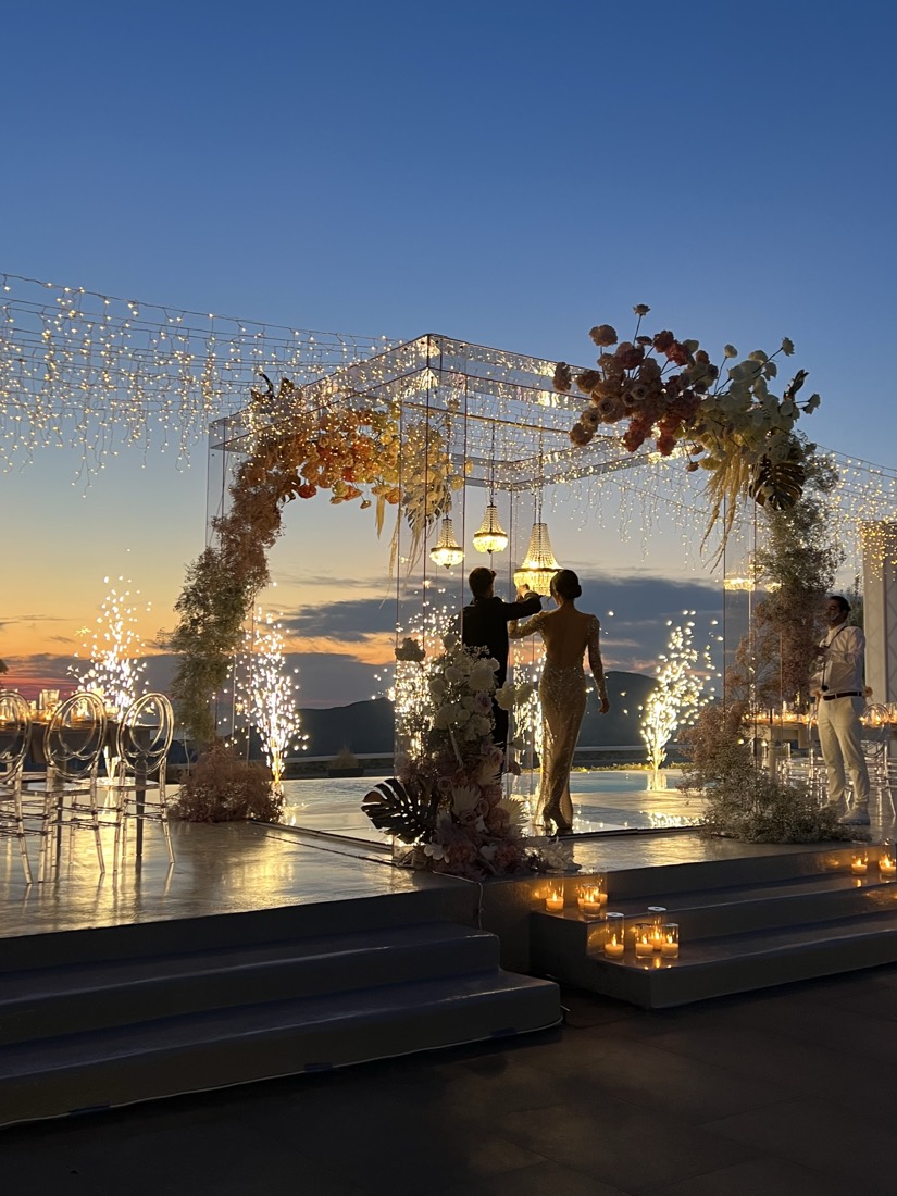 Ground fountains beside a pool at sunset